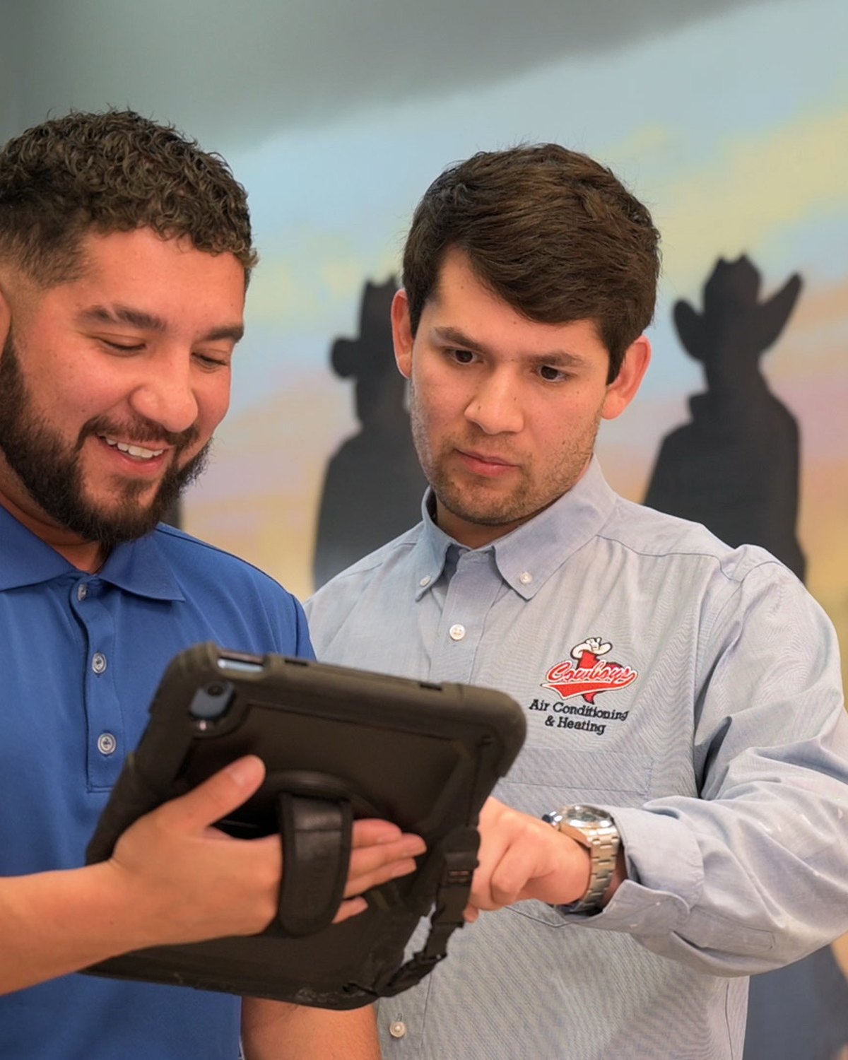 Cowboy's team walking through system options on a tablet
