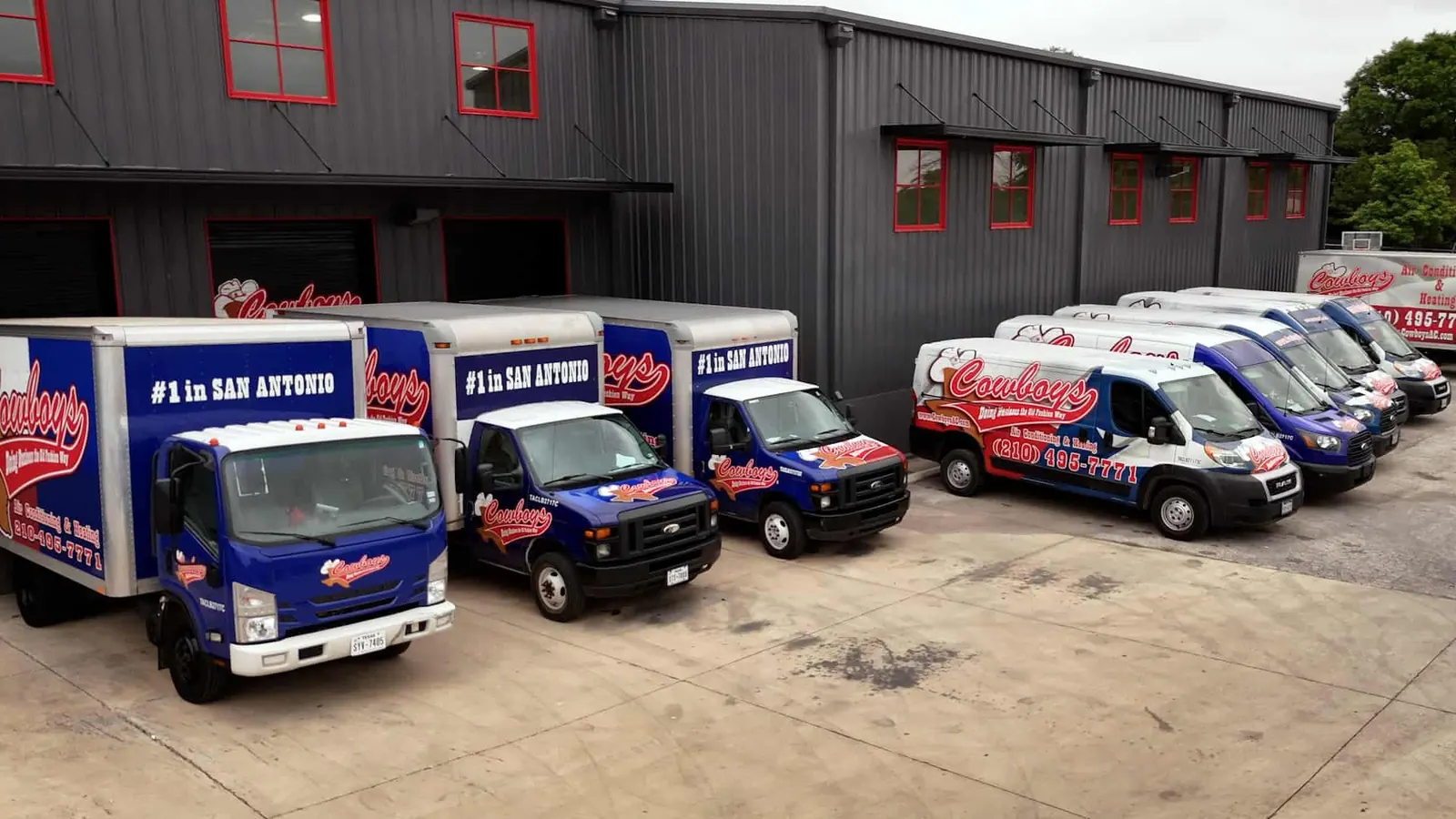 The Cowboy's box trucks and vans lined up outside the shop